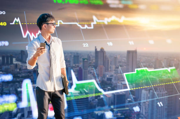istock Young business man using laptop and digital tablet cityscape background 668647806