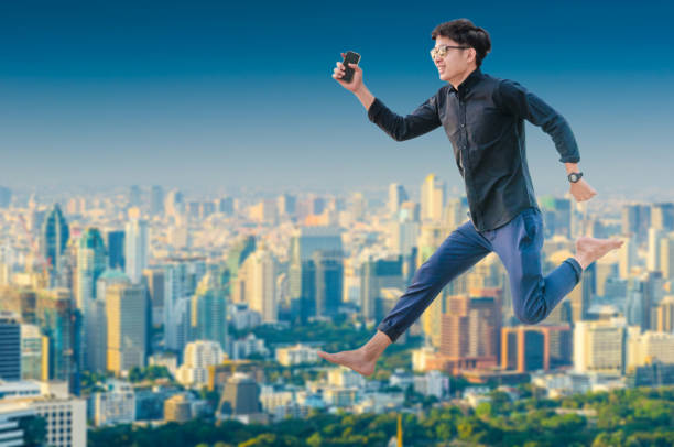istock Young business man using laptop and digital tablet cityscape background 668650608