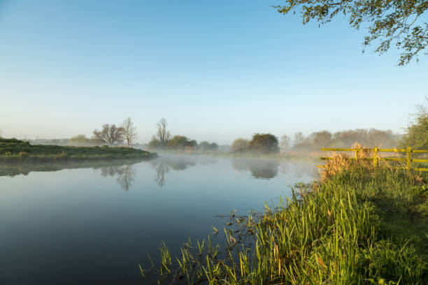 Mist hanging over river Nene in Northamptonshire at sunrise stock photo