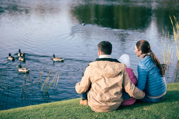 istock Family looking at lake with ducks 668657482