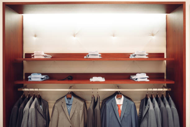 istock Shelves with men's shirts and a hanger with suits 668657846