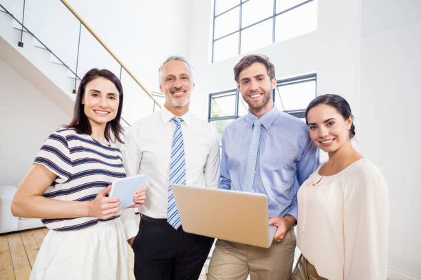 istock Business people holding digital tablet and laptop 668664306