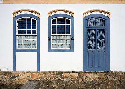 Colonial house façade door and dark blue window