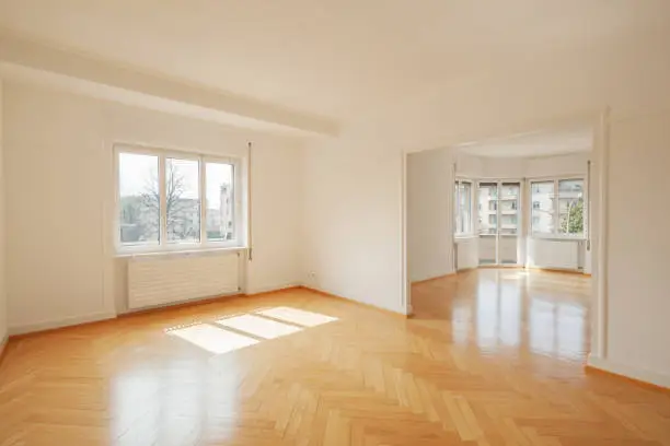 Interior of a modern empty apartment with big windows