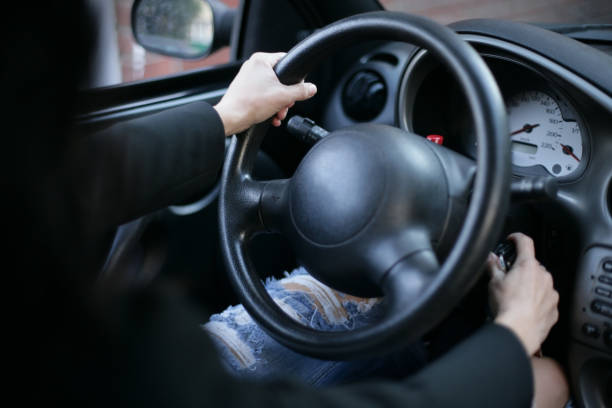 istock Woman hands on car wheel 668667164