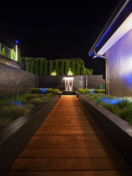 istock luxury garden with a fountain at night 668670936