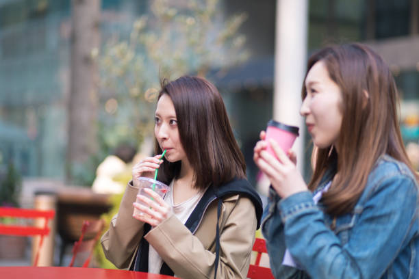 istock Young women taking break at street cafe 668671132
