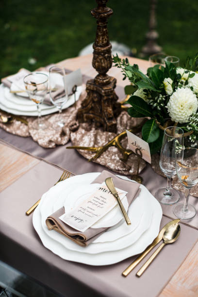 istock Backyard picnic table with plates and invitation 668671250