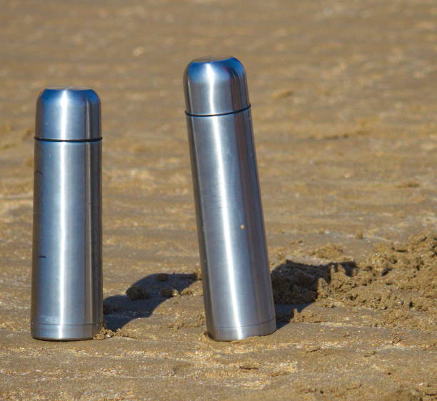 Thermos flasks on the beach stock photo