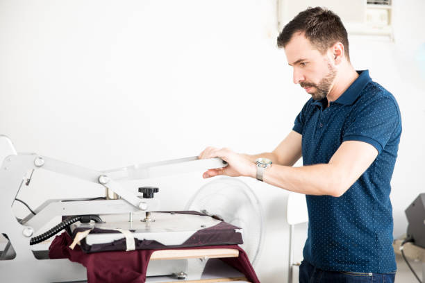 istock Man printing shirt in a workshop 668674654