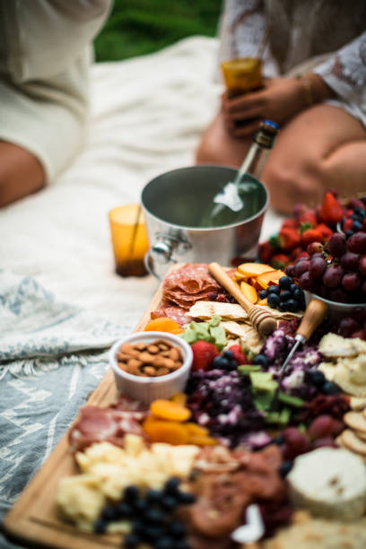 istock woman reaches toward cheese plate 668678294