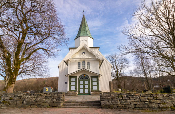 istock White church and blue sky with small clouds in Norway 668685220