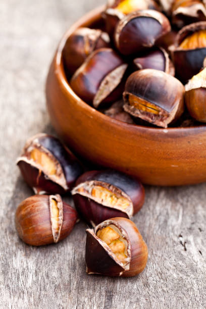 istock Roasted  chestnuts on wooden background 668686404