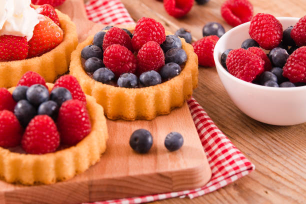 istock Tartlets with forest fruits. 668687354