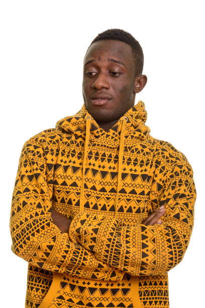 istock Young handsome African man looking down with arms crossed 668688370