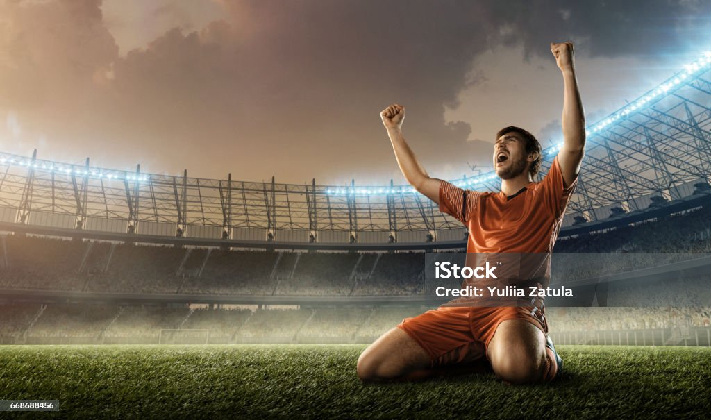 soccer player celebrating a victory soccer player celebrating a goal on a soccer field Soccer Player Stock Photo