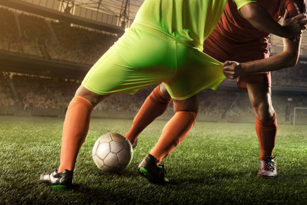 istock soccer players fighting for a ball 668689776