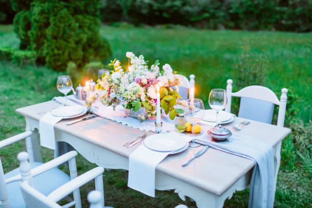 istock Table setting with dishes, cutler, candles and floristic. European wedding 668691548