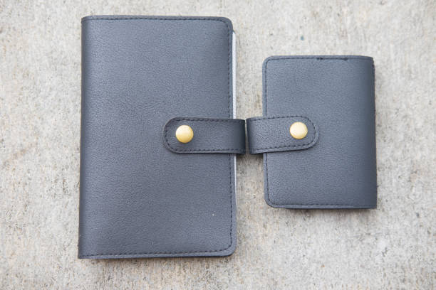 istock Man hand made leather wallet on concrete background 668694722