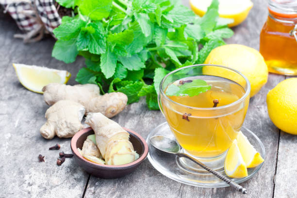 istock Herbal  tea with lemon and ginger on wooden table 668694766