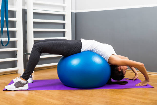 istock Fitness woman practicing with pilates ball 668695442