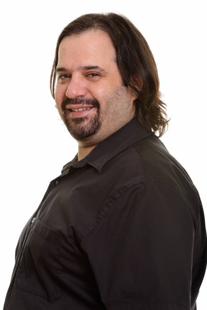 istock Face of happy overweight bearded man smiling while looking at camera against white background 668697638