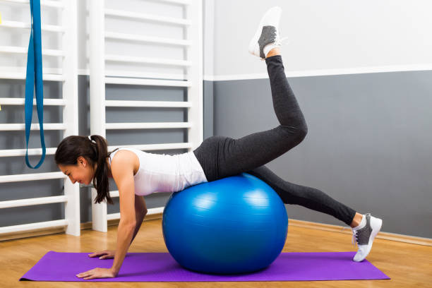istock Fitness woman practicing with pilates ball 668698142
