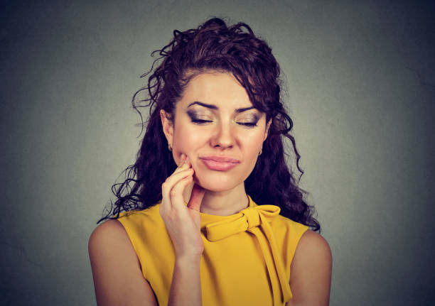 istock Woman with sensitive tooth ache crown problem about to cry from pain 668700946