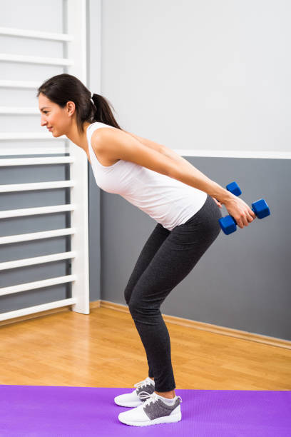 istock Fitness woman practicing with weights 668701740