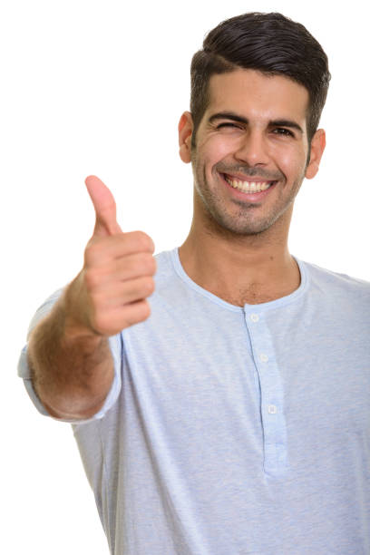 istock Young happy Persian man smiling and giving thumb up 668704922