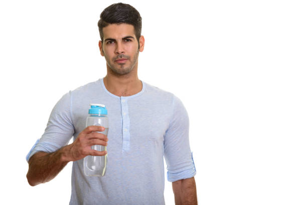 istock Young handsome Persian man holding water bottle 668705184