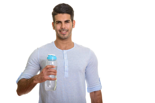 istock Young happy Persian man smiling and holding water bottle 668705200