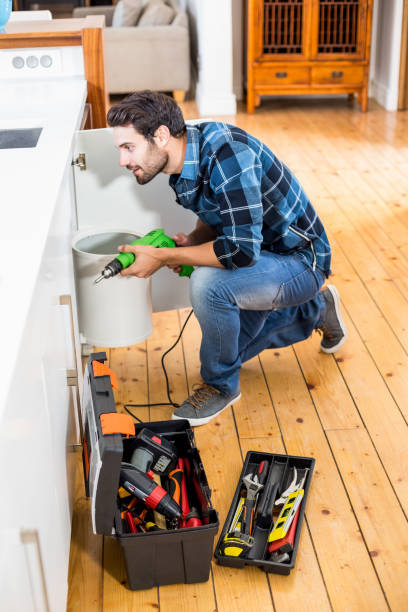 istock Man drilling a hole inside the cabinet 668707554