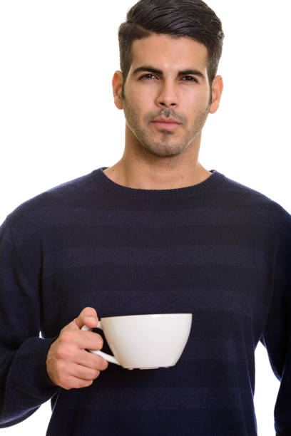 A sophisticated black and white (grayscale) photograph of a take-away coffee cup featuring a clean geometric pattern and a light-colored lid. The cup is centrally placed on a dark, plain background, offering generous negative space for text. This high-contrast, monochrome image is ideal for classic branding, formal editorial content, minimalist design, and advertising requiring a strong, uncluttered visual.