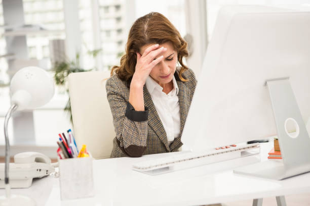 istock Overworked casual businesswoman working with computer 668710606
