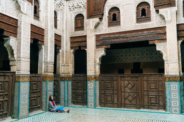istock Woman sitting inside riad in Morocco 668711074