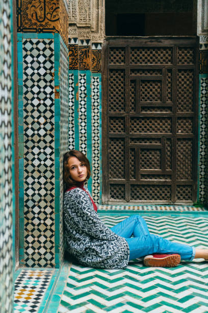 istock Woman sitting inside riad in Morocco 668711096