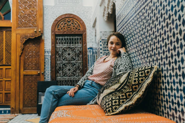 istock Woman sitting inside riad in Morocco 668711134