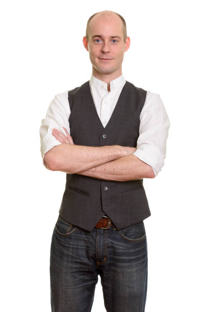 istock Bald handsome businessman standing with arms crossed 668712126