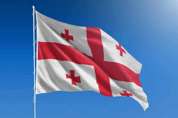 National flag of Georgia on clear blue sky The National flag of Georgia blowing in the wind in front of a clear blue sky georgia flag country stock pictures, royalty-free photos & images