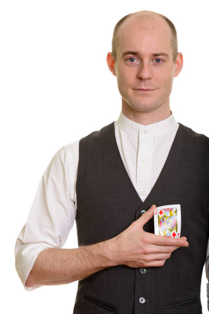 istock Bald handsome magician man bending Jack of Diamonds card 668712482