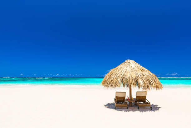 istock Beach chairs with umbrella and beautiful sand beach 668722024