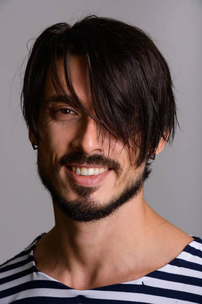 istock Face of happy handsome man smiling with bangs 668730606