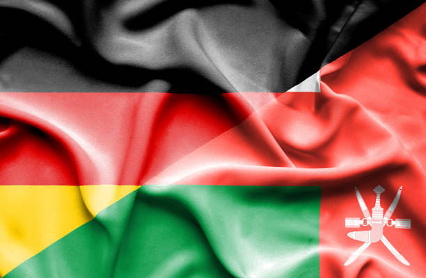 istock Waving flag of Oman and Germany 668735702