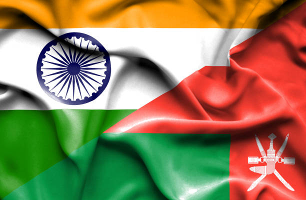 Waving flag of Oman and India Waving flag of Oman and oman stock illustrations