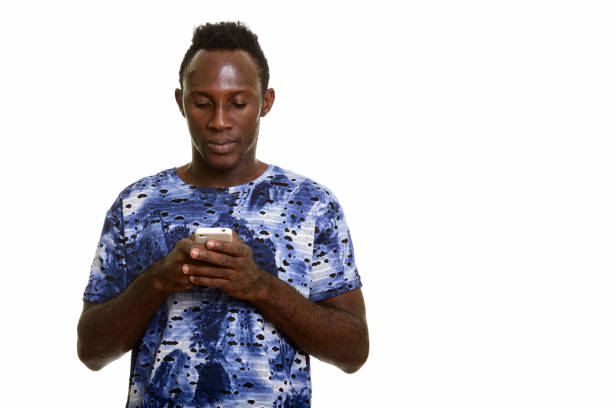 istock Studio shot of young black African man using mobile phone 668741118