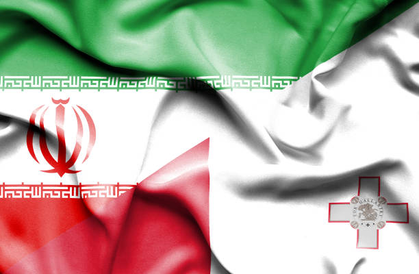 istock Waving flag of Malta and Iran 668741124