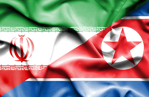 Waving flag of North Korea and Iran