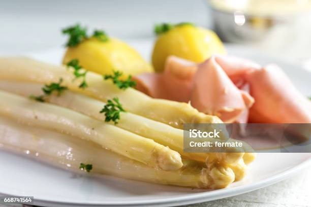White Asparagus Potatoes Ham Sauce Hollandaise On A White Plate Stock Photo - Download Image Now