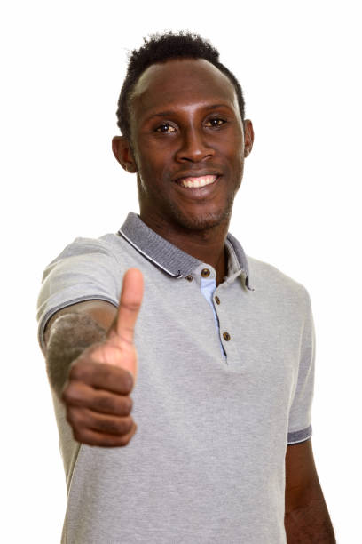 istock Young happy African man smiling and giving thumb up 668743980